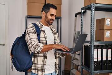 Sticker - Young hispanic man ecommerce business worker using laptop at office