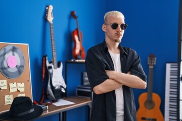 Sticker - Young caucasian man artist standing with arms crossed gesture at music studio