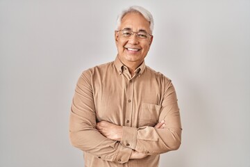 Poster - Hispanic senior man wearing glasses happy face smiling with crossed arms looking at the camera. positive person.