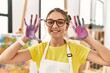 © Krakenimages.com - Adorable girl smiling confident showing painted palm hands at art studio