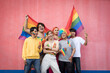 © Pituk - Happy Asian young friends holding rainbow flag celebrating gay pride festival - LGBTQ community concept
