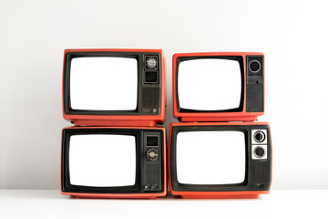 Wall Mural - Pile of red old retro television cut out blank screen on white wall background, front view