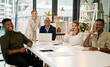 © K Seisa/peopleimages.com - Smiling, diverse and creative marketing team sitting in a boardroom meeting for startup business or company. New happy young people getting coaching from mature entrepreneur leaders using a laptop