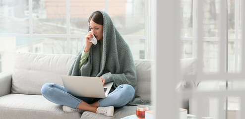 Canvas Print - Sick young woman with laptop working at home