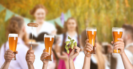 Poster - Group of friends with glasses of beer and sausage during celebration of Octoberfest outdoors