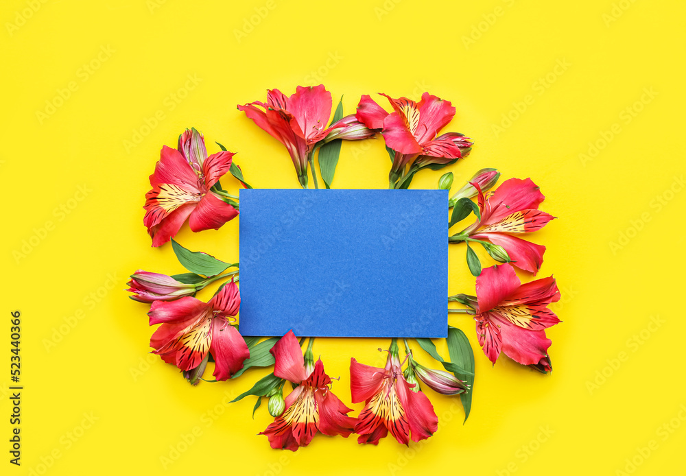 Composition with blank card and alstroemeria flowers on color background