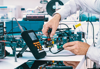 Canvas Print - Assembling and adjust the electronics instrument for precision physical measurements