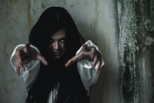 Scary Ghost Woman. Asian Ghost Or Zombie Horror Creepy Scary Have Hair Covering Face And Eye Reach Arm Out At Abandoned House Dark Room, Female Makeup Terror Zombie Face, Happy Halloween Day Concept