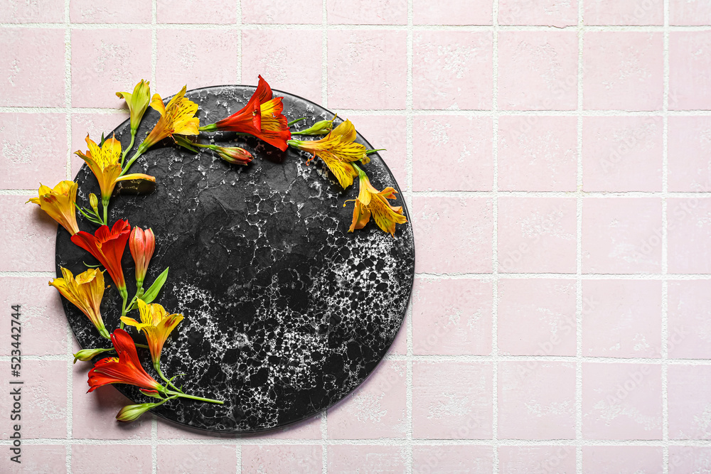 Composition with board and beautiful alstroemeria flowers on color tile