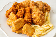 Fried Chicken With French Fries And Nuggets On Plate