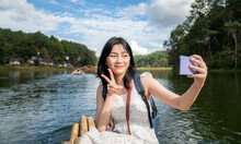 Asian Traveller Girl Selfie On The Bamboo Boat At Pangung