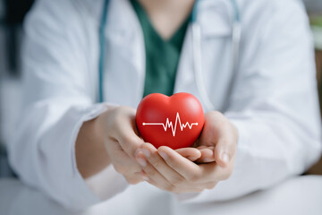 Doctor hands holding red heart in concept healthcare,wellbeing, organ donation and insurance life. world heart day and world health day National Organ Donor Day.