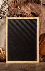 Fototapete - blank blackboard frame with kitchenware on wood table with sunlight