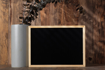 Fototapete - blank blackboard frame with kitchenware on wood table with sunlight