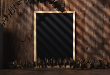 Fototapete - blank blackboard frame with kitchenware on wood table with sunlight