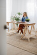 © Westend61 - Businesswoman talking on smart phone using laptop at home office