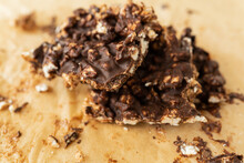 Close-up Texture Of Peanut Butter, Puffed Rice And Chocolate, Very Tasty DIY Dessert, Dessert Slices On Parchment.
