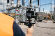 © andrew_shots - Adult videographer shoots a video about a modern power plant. Close up