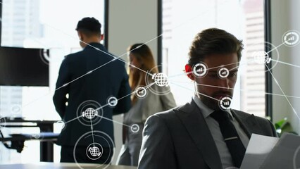 Poster - Caucasian man analyzing reports and rear view of coworkers with computer application icons
