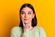 © Tetiana - Photo of young woman finger touch chin look empty space think clever isolated over yellow color background