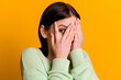 © Tetiana - Photo of young girl cover face hands look eye spy scared frightened isolated over yellow color background