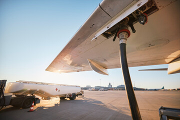 Refueling of airplane at airport. Ground service before flight. .