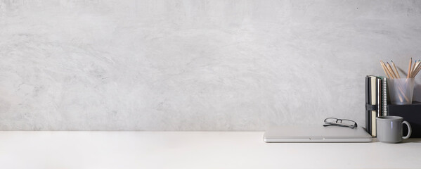 Wall Mural - Home office desk with supplies, mug, laptop and laptop on white table.  Copy space for your text.