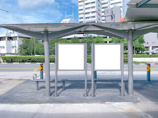 Wall Mural - Two bus stop blank advertising mock ups at empty bus stop shelter by main road. Out-of-home OOH classifieds billboard advertisement media in the city