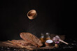 still life depicting slices of fresh bread, chestnut, honey, wheat and salt, shot in dark colors