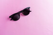 Black sunglasses on pink background