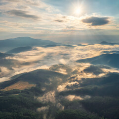 Wall Mural - amazing aerial view of beautiful low clouds creeping on the tree-covered mountain slopes, the rhodop