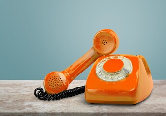 Wall Mural - A old retro telephone with the receiver off the hook on a table.