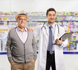 Poster - Doctor and an elderly male patient standing in a pharmacy