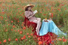 A Young Girl In A Flowering Poppy Field