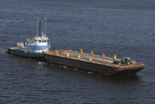 View Of Tugboat Pushing A Heavy Barge On The Sea, Florida Usa