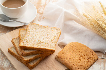 Sliced whole wheat bread on wooden cutting board,healthy food concept