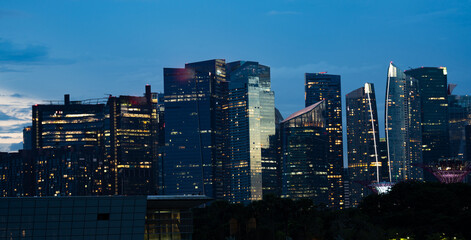 Wall Mural - Singapore city skyline with modern skyscraper architecture building for concept of financial business and travel in Asia cityscape urban landmark, marina bay at night district dusk sky