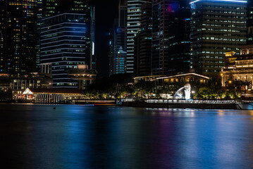 Wall Mural - Singapore city skyline with modern skyscraper architecture building for concept of financial business and travel in Asia cityscape urban landmark, marina bay at night district dusk sky