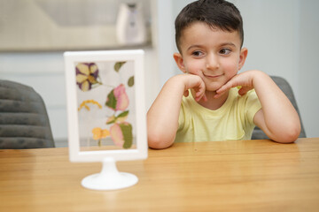 Wall Mural - Child look at the herbarium frame. Selective focus on boy.