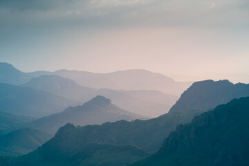 Wall Mural - View of the mountains and hills at sunset. Summer landscape