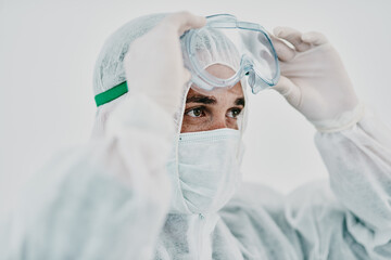 Aufkleber - Covid, pandemic and healthcare worker wearing protective ppe to prevent virus spread at a quarantine site or hospital. Closeup of a doctor or scientist wearing a hazmat suit and goggles for safety
