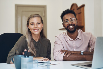 Poster - Happy diverse employees working together on a project sitting in an office table satisfied with the partnership. Portrait of young colleagues with a positive mindset smiling about business growth