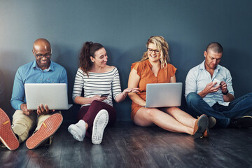 Aufkleber - Smiling, diverse group of casual and modern business people with their digital devices on social media networking apps. Happy, connected team of colleagues sitting, working on laptop pcs and phones