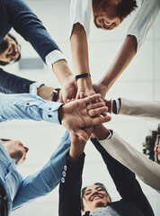 Poster - Teamwork, collaboration and unity between business people with their hands stacked for project development and innovation. Group of corporate colleagues united, joining or working together from below