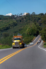 Wall Mural - Yellow truck on a rural road in Colombia