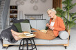 © ArtSys - Attractive senior woman with grey hair watching movies or tv show at home. Concept of mature female using technology, active lifestyle of pensioner, enjoying life