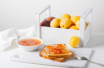 Wall Mural - Toasts of bread with apricot jam and fresh fruits