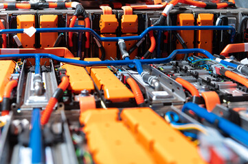 Wall Mural - Electric car battery with power connections closeup. Blue toned. EV car battery at maintenance.