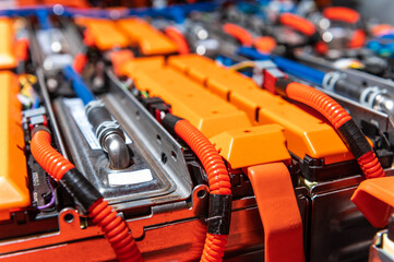 Wall Mural - Electric car battery with power connections closeup. Blue toned. EV car battery at maintenance.