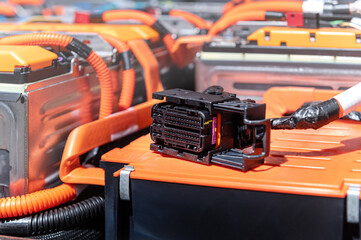 Wall Mural - Electric car battery with power connections closeup. Blue toned. EV car battery at maintenance. High voltage power connector closeup.